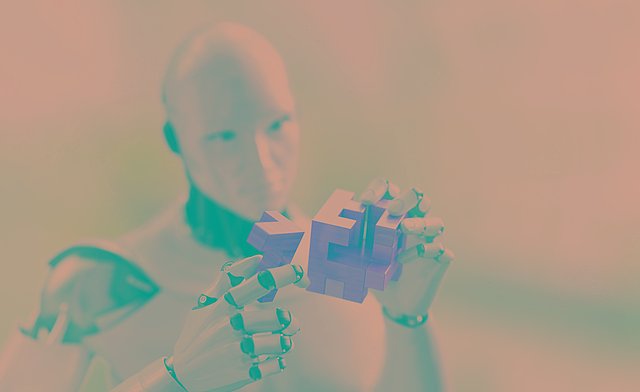 Ein menschenähnlicher Roboter betrachtet etwas, das er in der Hand hält
